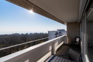 a balcony with a view of the ocean at Panoramic App B07-1 in Sierksdorf