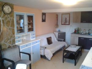 a living room with a couch and a table at Do Vuceljica in Andrijevica