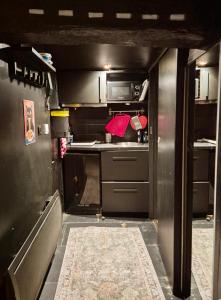 a kitchen with stainless steel cabinets and a stove at 17m2 Flower studio dans le centre historique Ecusson in Montpellier +9 photos