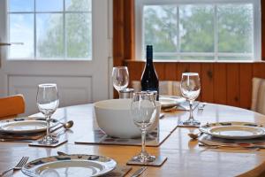 a table with plates and glasses and a bottle of wine at Castle Peroch in Dunkeld +18 photos