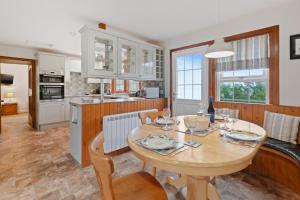a kitchen and dining room with a wooden table and chairs at Castle Peroch in Dunkeld