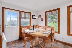 a dining room with a wooden table and chairs at Castle Peroch in Dunkeld