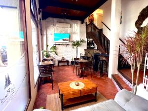 a room with a table and chairs and a staircase at Hotel Los Pinos in Colonia del Sacramento
