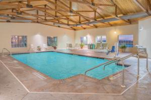 a large swimming pool in a large room with a large at Microtel Inn & Suites by Wyndham Quincy Downtown - River Area in Quincy