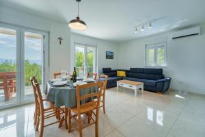 a dining room and living room with a table and chairs at Holiday house Gloria in Vrbnik