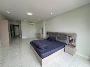 a bedroom with a large bed with purple sheets at Ashmita Shahi House in Kathmandu