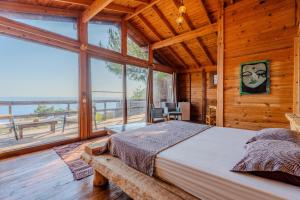 a bedroom with a bed in a room with windows at 11-11Shambala in Fethiye