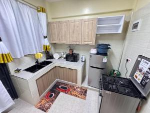 a small kitchen with a sink and a refrigerator at Riverview greenstar homes in Kisii