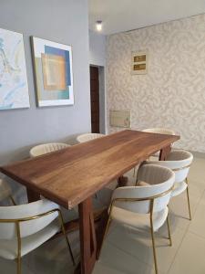 a dining room with a wooden table and chairs at C7 double up in Camama