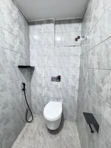 a bathroom with a toilet and a shower at Riverview greenstar homes in Kisii +3 photos