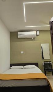 a hospital room with a bed and a fan at S J RESiDENCY in Trivandrum +17 photos