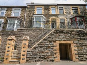 an old brick building with a staircase on it at 5 Gelli Terrace in Caerphilly