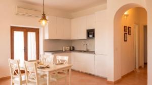 a kitchen and dining room with a table and chairs at Casa della Marina - beach, seaview, wifi in Conca dei Marini