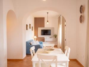 a living room with a table and a blue couch at Casa della Marina - beach, seaview, wifi in Conca dei Marini