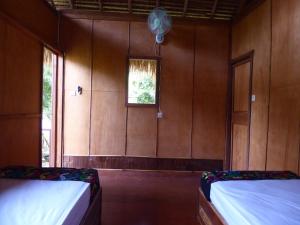 a room with two beds and a window at Shibui Garden Bungalows and Restaurant in Tanjung