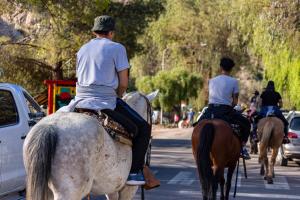 a group of people riding horses down a street at Condominio Diamante in San Rafael