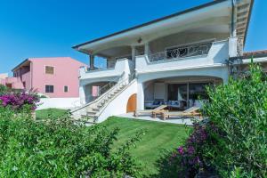 a house with a staircase leading to a patio at Residence il Gabbiano in Palau