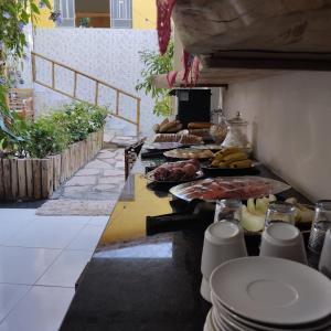a buffet line with different types of food on at Pousada Mandala in Palmeiras