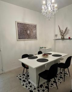 a dining room with a white table and chairs at Chloè Vacanze in Iesi