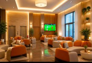 a lobby with couches and a tv in a building at Hotel Deauville El jadida in El Jadida