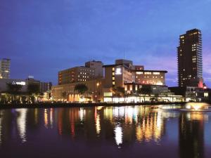 a city skyline at night with a body of water at Akita Castle Hotel in Akita