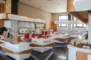 a restaurant with several counters with food on display at Hotel Deauville El jadida in El Jadida