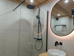 a bathroom with a shower with a sink and a mirror at Hôtel Mont Thabor Serre Chevalier in La Salle-les-Alpes +36 photos