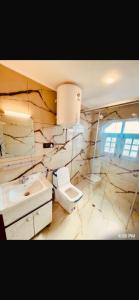 a white bathroom with a toilet and a sink at Rahat Resort in Srinagar +25 photos