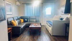 a living room with a couch and a coffee table at Wasaga Daze - Unit A in Wasaga Beach +11 photos
