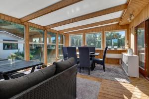 an open living room with a table and chairs at Feriehus 1149 in Ringkøbing