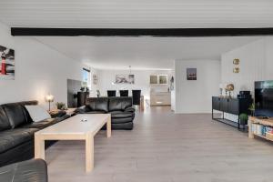 a living room with a couch and a table at Feriehus 1149 in Ringkøbing