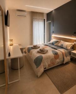 a bedroom with a large bed and a white table at Altea in Taurianova +5 photos