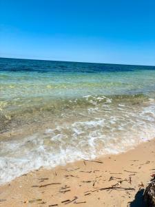 a sandy beach with the ocean in the background at Dar Tantana sayafi in Hammam Sousse +2 photos