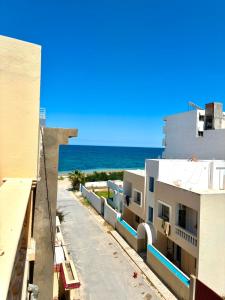 a view of the ocean from a building at Dar Tantana sayafi in Hammam Sousse