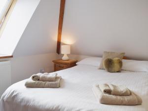 a bedroom with a bed with towels on it at Chive - E4326 in Catfield