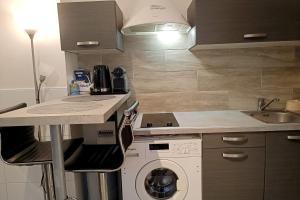 a kitchen with a washing machine and a sink at Bright and quiet studio in Nice in Nice