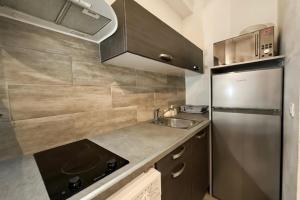 a small kitchen with a sink and a refrigerator at Bright and quiet studio in Nice in Nice