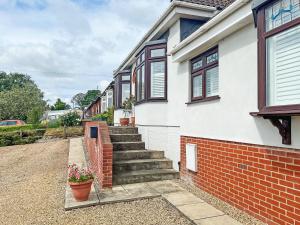 a house with a brick stairway with potted plants at Vine - Uk51860 in Ely