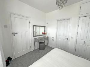a bedroom with a bed and a mirror and a table at Vine - Uk51860 in Ely