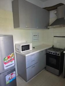 a kitchen with a microwave and a refrigerator at L28 double up apartament in Camama