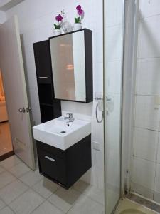a bathroom with a sink and a mirror at L28 double up apartament in Camama