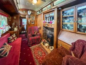 a train room with a couch and a fireplace at Romney Wagon in Hailsham