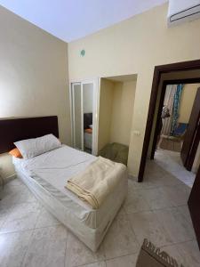 a large bed in a room with a mirror at El wadi Pearl Residence in Ain Sokhna