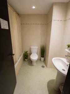 a bathroom with a toilet and a sink at El wadi Pearl Residence in Ain Sokhna