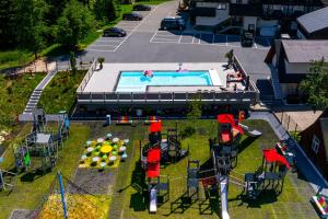an aerial view of a swimming pool with a toy lighthouse at Apartamenty Grand Tatry - sauna i jacuzzi wliczone w cenę pobytu - 10 minut pieszo od Term Bania - znajdują się one w budynku obok in Białka Tatrzańska
