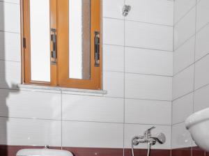 a bathroom with a mirror and a sink and a toilet at Vila Anna in Ksamil +27 photos
