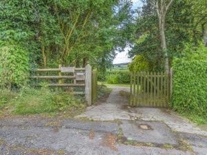 a gate with a wooden fence in a field at Steep Holm in Kington