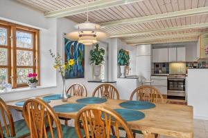 a kitchen and dining room with a wooden table and chairs at SJ214-Fredericia-Lillenaes-71 in Fredericia