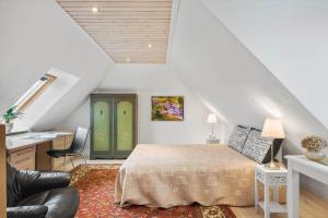 a bedroom with a bed and a desk and a chair at SJ214-Fredericia-Lillenaes-71 in Fredericia