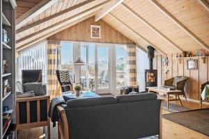 a living room with a couch and a fireplace at SJ225-Hejls-Humlevaenget-6 in Hejls